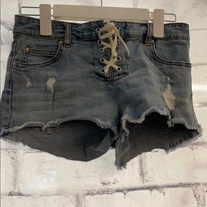 Ripped denim jeans with corset tie up front